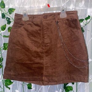 Never worn straight mini skirt with a chain and a zipper and button on the front